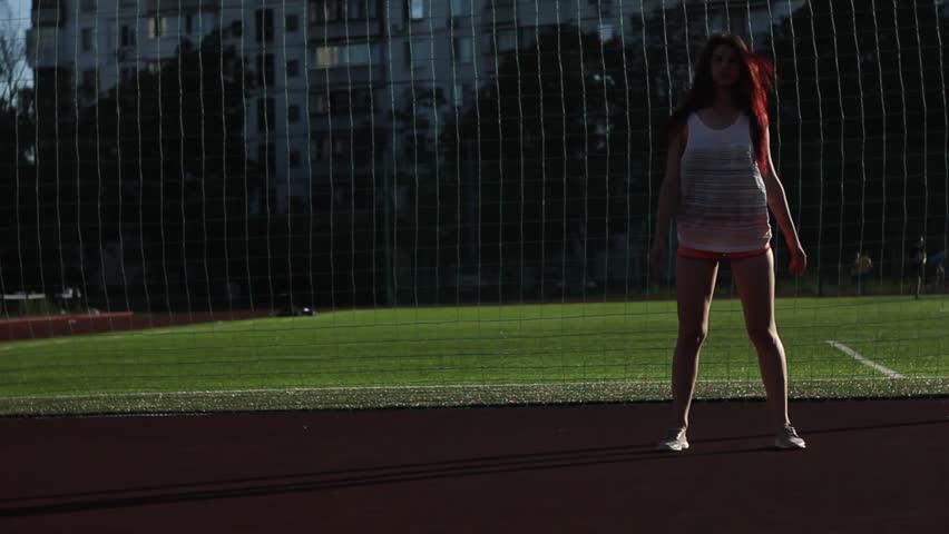 Girl doing sport exercise at the stadium