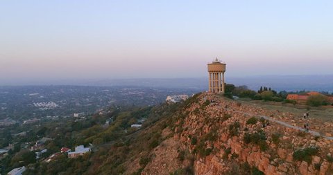 An aerial shot of the water tower atop Northcliff Hill, the second highest point in Johannesburg, South Africa shot at sunset. In the background, Sandton and a large part of Randburg can be seen.