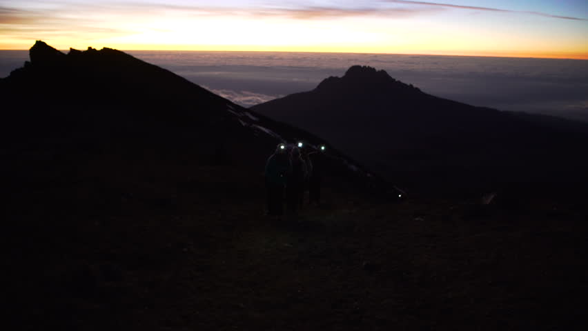 Group of people climbing Mount Kilimanjaro on the night with headlamp flashlight, Stella  Tanzania, Africa. Climbing the mount Kilimanjaro, Stella Point  Uhuru Peak