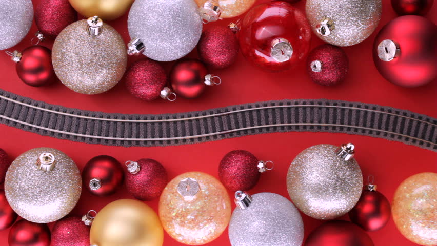 Electric train passing through colorful christmas tree ornaments
