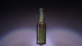 Glass Bottle Shatters and Sprays Mist - A glass bottle in front of a grey background explodes into pieces and sprays tiny droplets of water mist across the screen - Powered by Shutterstock - Get 15% off with code: PIKWIZARD15