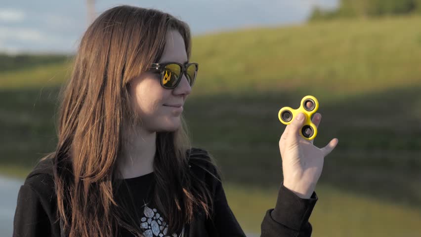 She twists the toy-spinner