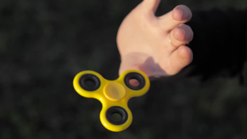 She twists the toy-spinner