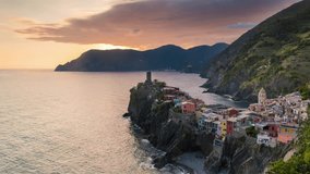 sunset and blue hour timelapse of travel landmark destination Vernazza, a small mediterranean sea town, Cinque terre National Park, Liguria, Italy. Clouds, flare, sunlight. 4k time lapse video shot