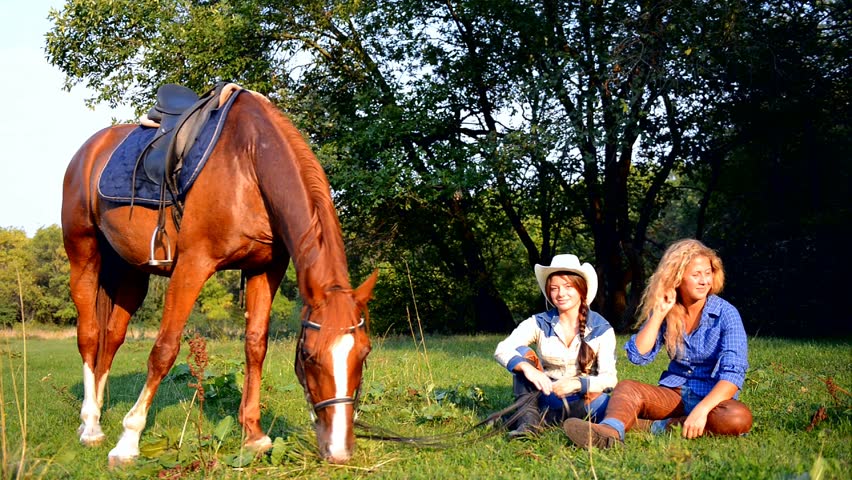 Two Beautiful Smiling Cowgirls with horse