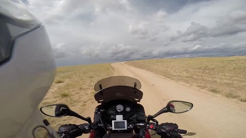 motorcyclist driving on desert