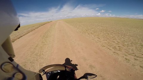 motorcyclist driving on steppe