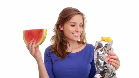 woman tempted by watermelon and potato chips chooses the red juicy fruit
