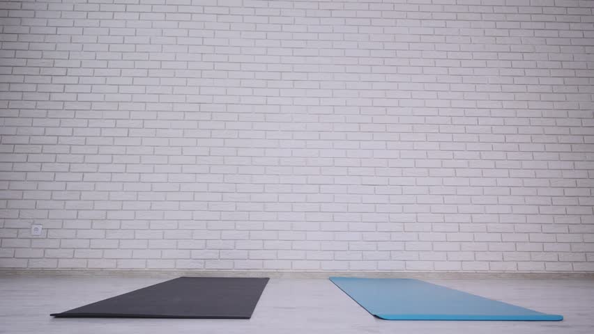 Couple doing yoga in studio.