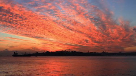 Breathtaking view over shimmering waters of Istanbuls magnificent Bosphorus. Sunset at Sarayburnu over Blue Mosque and Hagia Sophia. Setting sun fired up the sky and Bosphorus waters
