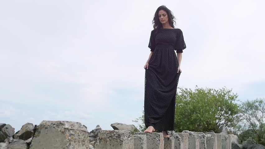 A beautiful girl is walking along the shore