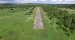 4K aerial drone video with bird's view of abandoned landing strip near Bolshevo, near Pereslavl-Zalesskiy on Golden Ring route 120 km from Moscow, Russia in summer day