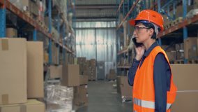woman worker in storehouse using wireless barcode scanner scanning labels on boxes before delivery in logistic center. professional employee wearing uniform high visibility orange hard hat and vest - Powered by Shutterstock - Get 15% off with code: PIKWIZARD15