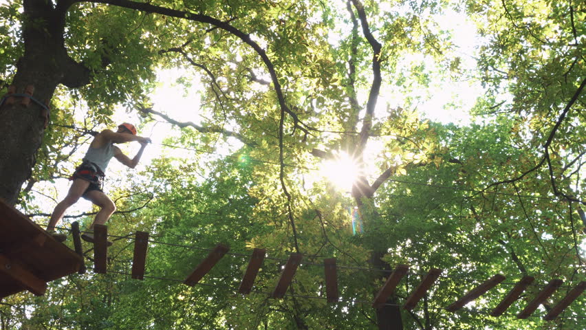 Man climbs on the ropes in entertainment park
