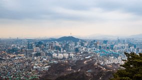 Time lapse day to night skyline of Seoul with Seoul tower, South Korea. Zoom in.