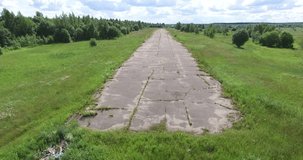 4K aerial drone video with bird's view of abandoned dilapidated landing strip near Bolshevo, near Pereslavl-Zalesskiy on Golden Ring route 120 km from Moscow, Russia in summer day
