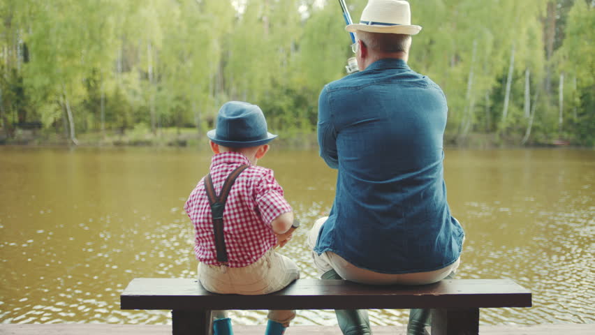 Grandfather and his grandson are casting lines during salmon fishing on the river Royalty-Free Stock Footage #29385130