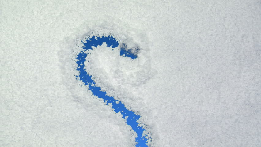 Heart drawn on snow background with matte