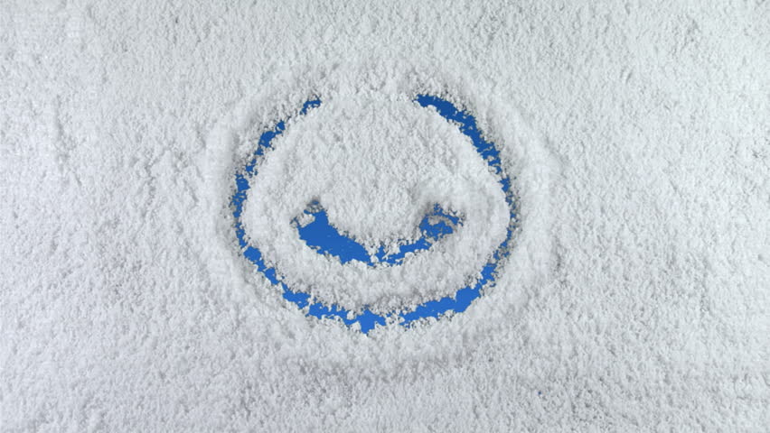 Smile symbol drawn on snow background with matte