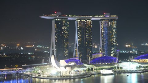 EL: Marina – Singapore January 9 2012: Time Lapse Singapore at Night. View to Marina Sands Resort in Singapore on January 9 2012