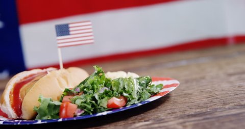 Close-up of hot dog french fries and hamburger served on plate against American flag - Βίντεο στοκ