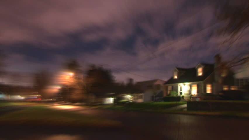 Night time lapse in residential neighborhood with person running in super speed