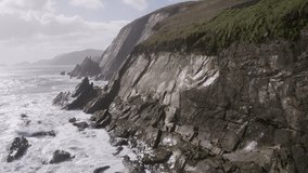 Aerial Footage Of Sea And Mountain Cliff Against Cloudy Sky
