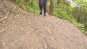 Tracking Shot Of Fit Woman Running On Trail In Forest