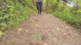 Tracking Shot Of Fit Female Athlete Running On Forest Trail