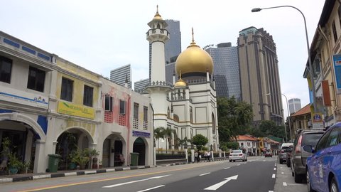 SINGAPORE - MAY 2017: Classic architecture of Sultan mosque contrasts with modern office skyscrapers in Singapore