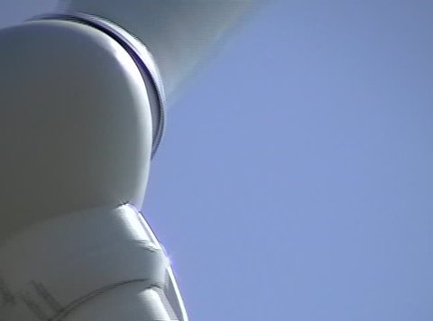 Extreme close-up of a white power-generating windmill.