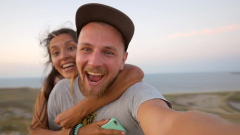 Young mixed race couple running piggyback and having fun. HD Slowmotion.