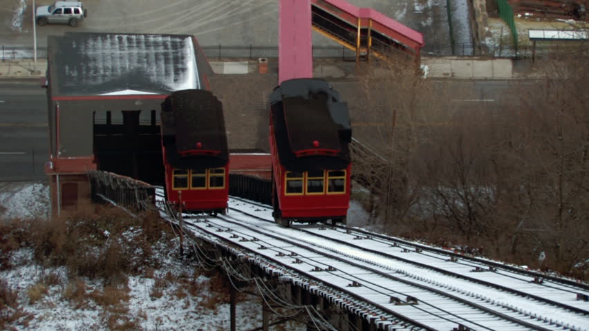 The Duquesne Incline cars traveling up and down Mt. Washington.