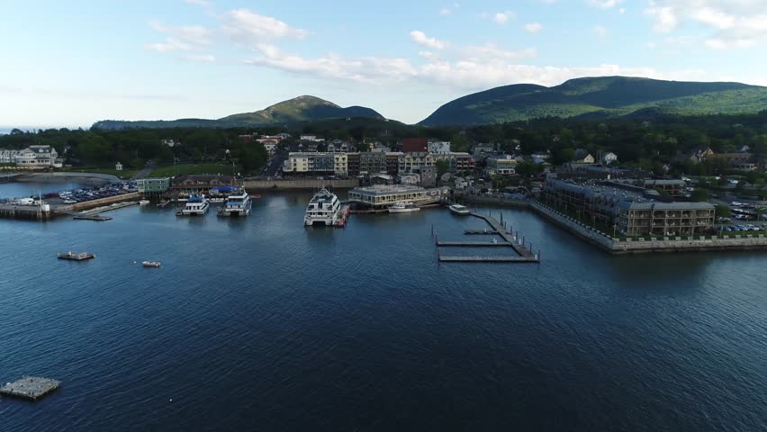 A moving aerial view of Bar Harbor Maine from the waterfront 