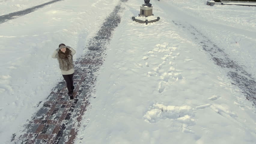 Young beautiful girl is circling around herself at the winter path | Shutterstock HD Video #29411992