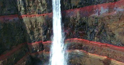 Ribbon Waterfall Emptying Over Red Banded Cliffs - Aerial Footage of Hengifoss Waterfall in Iceland