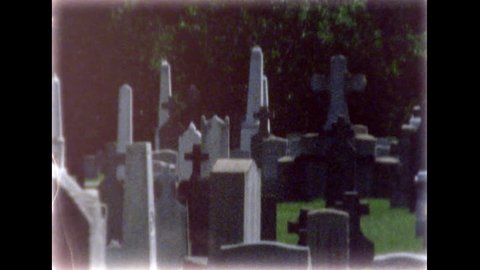May 2016. First Calvary Cemetery in Queens. Graves and car traffic. Dynamic camera work moving from graves to Kosciusko Bridge. 8mm film footage. Filmed on super8 film tape, with Super8 camera.