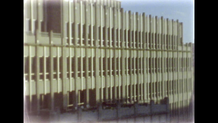 Buildings in Arlington, VA. Skyline. Perspective view of the street. Clear sky. Late afternoon sunlight. 8mm film footage. Filmed on super8 film tape, with Super8 camera.