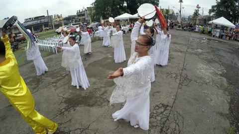 San Pablo City, Laguna, Philippines - August 2, 2017: Mature women in white gown dancing in praise to honor El Shaddai