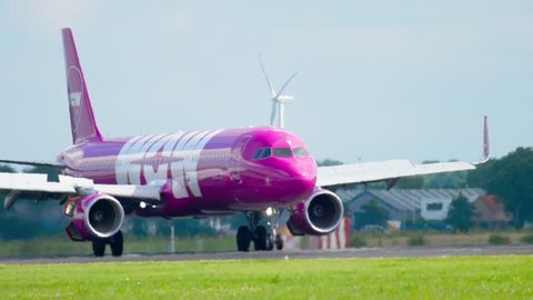 AMSTERDAM, THE NETHERLANDS - JULY 26, 2017: WOW Air Airbus 321 TF-JOY braking after landing on runway 18R Polderbaan. Schiphol Airport, Amsterdam, Holland