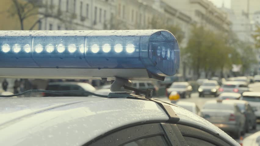 Police patrol car. Blinking police flasher during the day