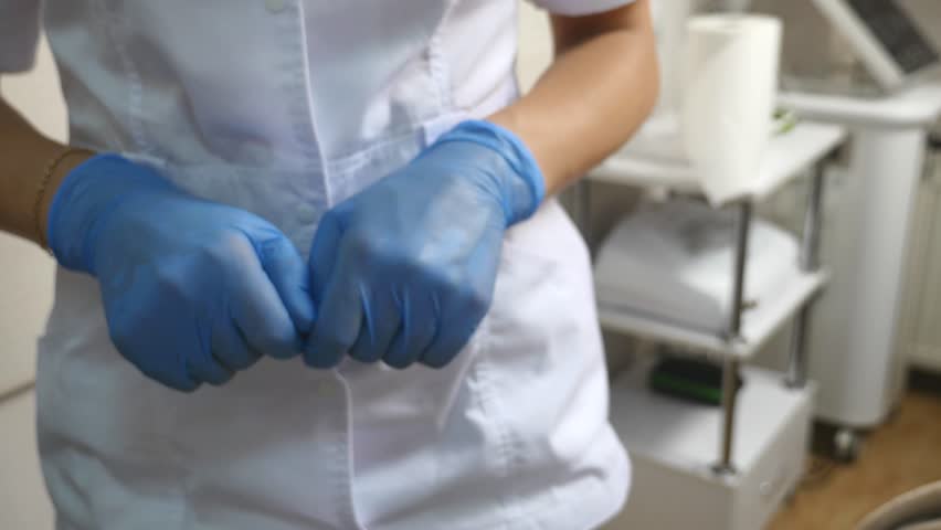 Blue latex medical gloves on a woman's hand. | Shutterstock HD Video #29439994