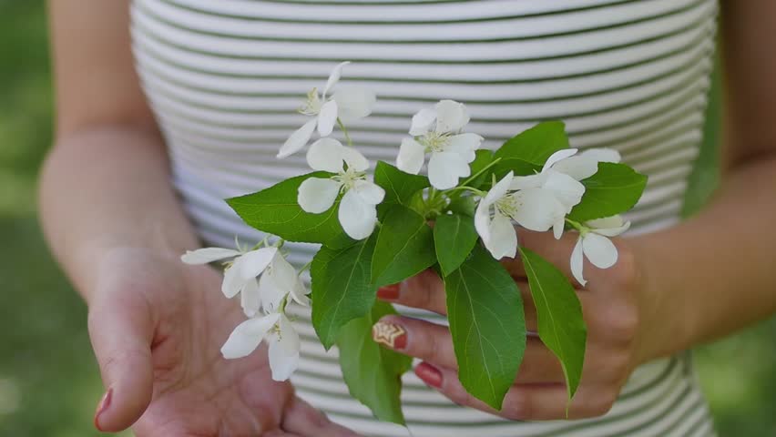 young woman enjoying in the background of the Apple tree