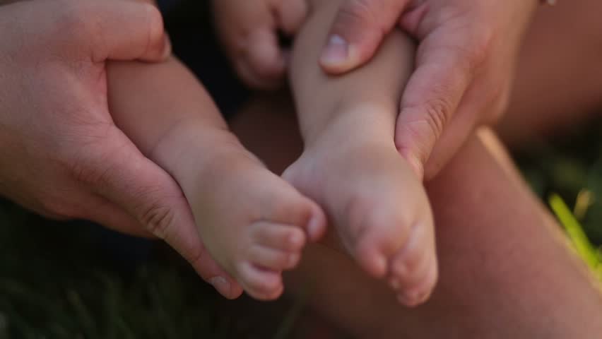 Tiny baby feet in caring father's hands | Shutterstock HD Video #29441623