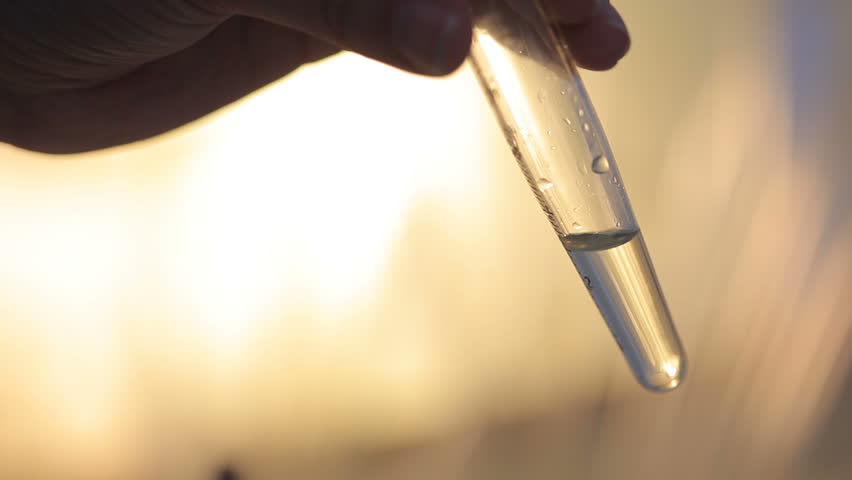 Laboratory experiment of ecology researches: close up shot of detecting ph level by litmus paper into glass vial. The vial has special marks in russian Royalty-Free Stock Footage #29442325