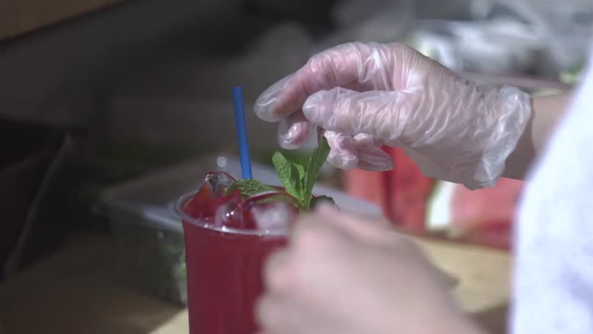 cucumber and watermelon. Bartender making fresh lemonade on street food festivale
