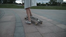 A girl is riding a longboard