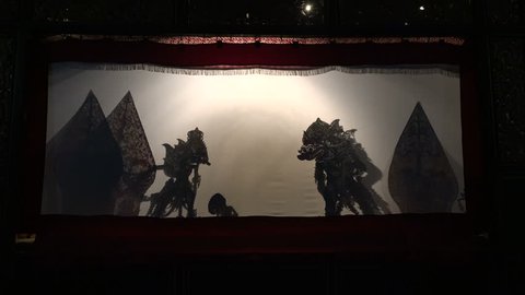 YOGYAKARTA, INDONESIA - APRIL 2017: Silhouettes of shadow puppets during traditional Wayang Kulit performance in theater in Yogyakarta, culture and tourism Indonesia