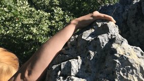 Young female climbs off the rock slow-mo 1920X1080 HD footage - Slow motion of woman descending the cliff 1080p FullHD video
