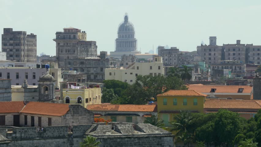 A high angle dolly establishing shot of the capitol dome in the old town section of Havana, Cuba. Shot in 5K.  	